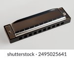 Harmonica on a white background, a classic musical instrument ideal for jazz, blues and folk music.