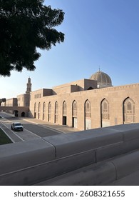 A harmonious blend of architectural structures and vehicular movement in a vibrant city setting.