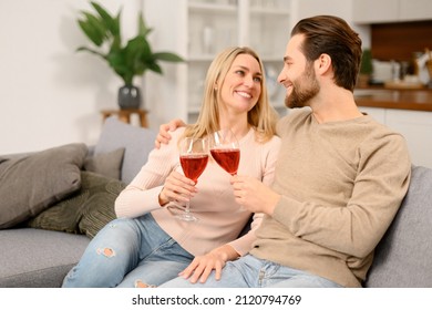 Harmonious Married Couple With Wine Having Romantic Date, Resting After Work Day At Home, Spending Time Together. Spouses Celebrating Important Date, Anniversary