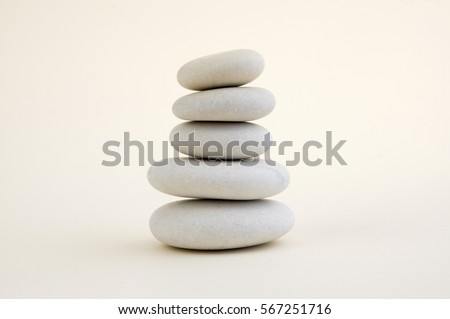 Harmony and balance, cairns, simple poise stones on white background, rock zen sculpture, five white pebbles, single tower, simplicity
