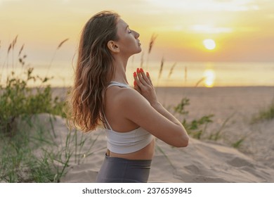Harmony and balance and concentration, relaxation time at sunset.  A slender woman Feels good and exercises for mindfulness. - Shutterstock ID 2376539845