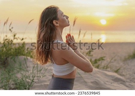 Harmony and balance and concentration, relaxation time at sunset.  A slender woman Feels good and exercises for mindfulness.