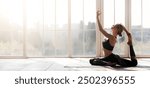 Harmony, balance, health concept. Peaceful girl practicing yoga at home, panoramic window background, copy space