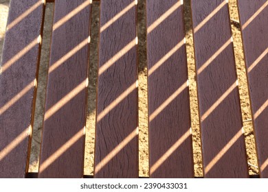 Harmony between the sunlight shining through the bench and the trees on the bench