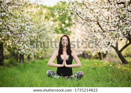 Similar – Young woman doing yoga in nature