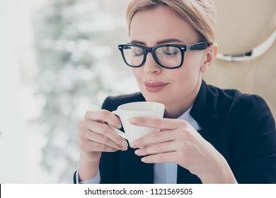 Harmony delight daydream concept. Close up portrait of calm pleased woman in eyeglasses holding cup with hot beverage in hands enjoying smell with close eyes - Powered by Shutterstock