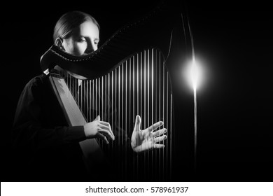 Harp Player. Classical Musician Harpist Playing Irish Harp Music Instrument Isolated On Black