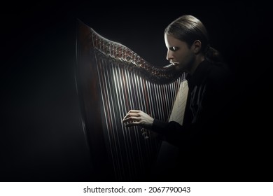 Harp Player. Irish Harpist Playing Celtic Music. Classical Musician