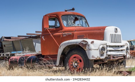 Harrah, WA USA June 9th 2013; Junk Yard Farm Equipment International Truck With Broken Windows