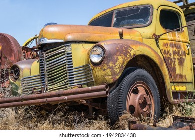 Harrah, Wa Usa June 9th 2013; Vintage Broken Farm Equipment International Truck Falling Apart In Junk Yard Field.