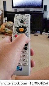 Harrisburg, PA - April 15, 2019 - Hand-held DirecTV Remote Aimed At Television.