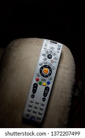 Harrisburg, PA - April 17, 2019 - DirecTV Remote On Arm Of Recliner With Plenty Of Copyspace.