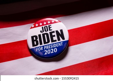 Harrisburg, PA - November 7, 2019 - Joe Biden Presidential Campaign Button Against US Flag. Selective Focus, Shallow Depth Of Field.