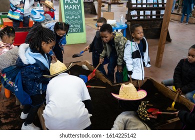 Harrisburg, PA / USA - January 9, 2020: Young Children Play And Dig In The Dirt At The Pennsylvania Farm Show.