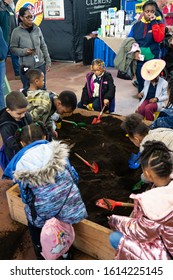 Harrisburg, PA / USA - January 9, 2020: Young Children Play And Dig In The Dirt At The Pennsylvania Farm Show.