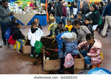 Harrisburg, PA / USA - January 9, 2020: Young Children Play And Dig In The Dirt At The Pennsylvania Farm Show.