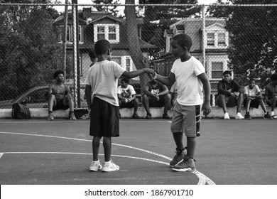 Harrisburg, Pennsylvania United States of America - July 10th 2019: two inner-city youth shake hands before playing basketball against each other in a summer youth program