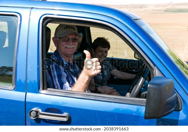 HARRISMITH, SOUTH AFRICA -\
Aug 11, 2021: A closeup of an elderly couple in the car \
Harrismith, South Africa\

