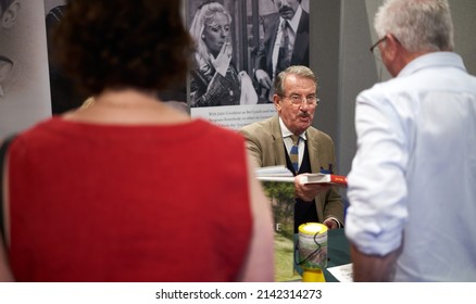 HARROGATE, YORKSHIRE, ENGLAND, UK - JULY 11, 2019: John Challis signing books at a book signing even for his book Wigmore Abbey at the Great Yorkshire Show.