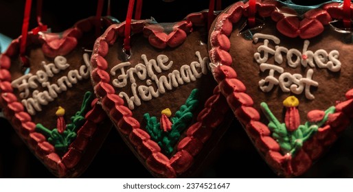 Hart Shaped Christmas cookies, as sold at the 2014 Christmas Market in Munster (Germany). Inscriptions wishing potential customers a Merry Christmas (Frohe Weinach) and a Happy Holiday (Frohes Fest).