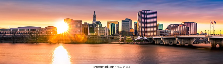 Hartford skyline and Founders Bridge at sunset. Hartford is the capital of Connecticut.