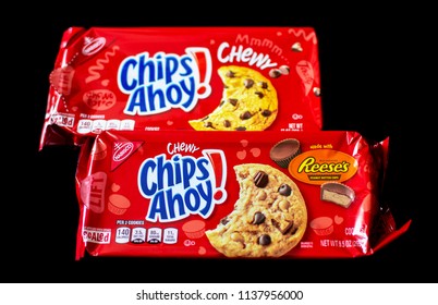 Hartland, WI/USA/July 19, 2018:  Chips Ahoy Chewy Chocolate Chip Cookies Packaging Next To Chips Ahoy Reese Peanutbutter Cup Chocolate Chip Cookies On A Black Background.  Packaging For Comparison.