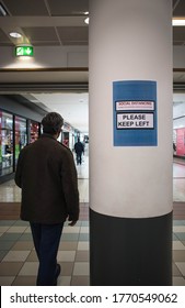 Hartlepool / Great Britain - July 6, 2020 : Social Distance Information Reminder Sign Saying Keep Left On In Shopping Centre Mall With Man Walking Past