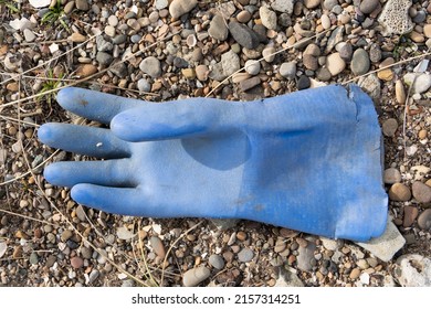 HARTLEPOOL, UNITED KINGDOM - Mar 13, 2022: Pollution  Discarded Rubber Glove, Washed Up On North Gare Beach, Near Hartlepool, UK