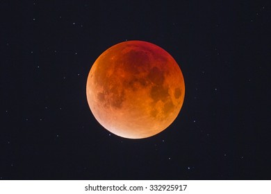 Harvest Blood Moon - Bright Orange Autumn Supermoon Lunar Eclipse In The Midnight Air With Stars In The Background