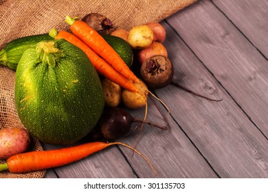 Harvest Fest. Fresh Organic Vegetables: Carrot, Potato, Sugar Beet And Vegetable Marrow On Rustic Wooden Background. Selective Focus. Toned Image