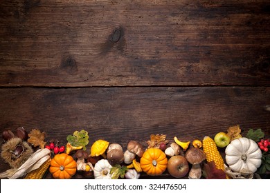 Harvest or Thanksgiving background with autumnal fruits and gourds on rustic wooden table