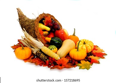 Harvest or Thanksgiving cornucopia filled with vegetables on a white background - Shutterstock ID 157218695