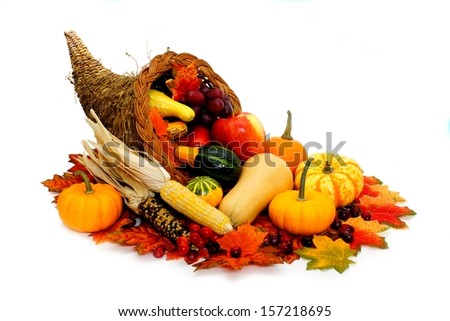 Harvest or Thanksgiving cornucopia filled with vegetables on a white background