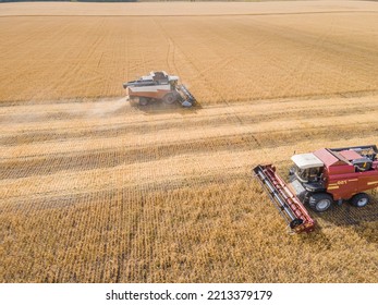 Harvest Wheat Grain And Crop Aerial View.Harvesting Wheat,oats, Barley In Fields,ranches And Farmlands.Combines Mow In The Field.Agro-industry.Combine Harvester Cutting On Wheat Filed.Machine Harvest