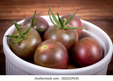 Harvested Fresh Black Cherry Cultivar Cocktail Size Tomatoes On A Bowl Closeup