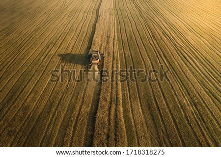 Similar – Combine harvester harvests grain field in the evening light from the air