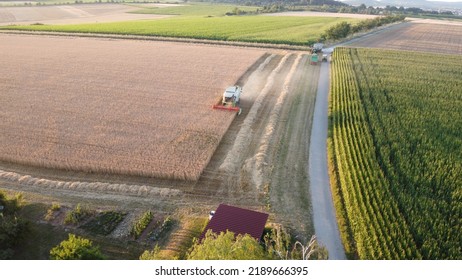 Harvester Threshing Wheat In A Beautiful Landscape