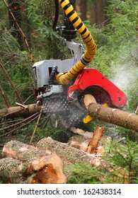 The Harvester Working In A Forest. Closeup With Shallow DOF. 