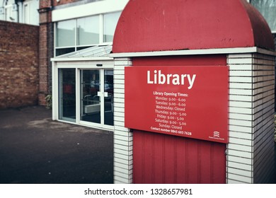 Harwich & Dovercourt, Essex, ENGLAND - March 3, 2019: Sign Showing Library Opening Times In Harwich With The Essex County Council Logo Bottom Left.