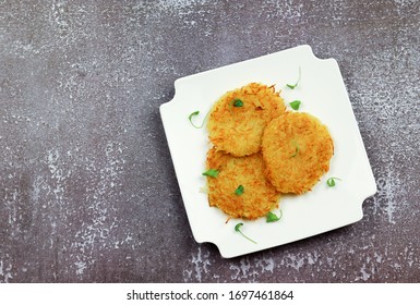 Hash Browns On A White Round Plate On A Light Gray Background. Top View, Flat Lay