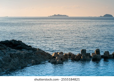 Hashima Island, commonly called Gunkanjima as mean Battleship Island, a tiny abandoned island off Nagasaki not far from the centre of the city, can be visited together with Meotoiwa for sightseeing - Powered by Shutterstock