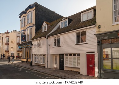 HASTINGS, EAST SUSSEX, UK - APRIL 30, 2012:  View along the High Street in the Old Town with the Duke of Wellington pub and shops
