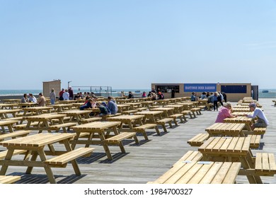 Hastings, UK - 30 May 2021: Hastings Pier Beer Garden And Bar Overlooking The Sea, Sussex