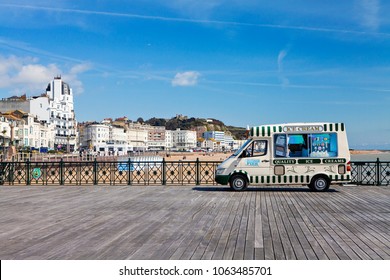 HASTINGS, UK - APRIL 5th, 2018: Ice cream van is selling ice creams on sunny day on pier in Hastings, East Sussex.