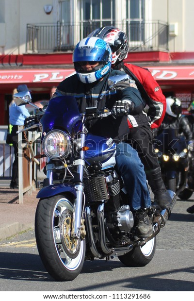 Hastings,East Sussex/UK 07/05/18 Bike 1066\
the annual May Day bike run to Hastings. A blue Suzuki motorbike\
with pillion passenger arrives on Hastings seafront to join\
thousands of other\
motorcycles