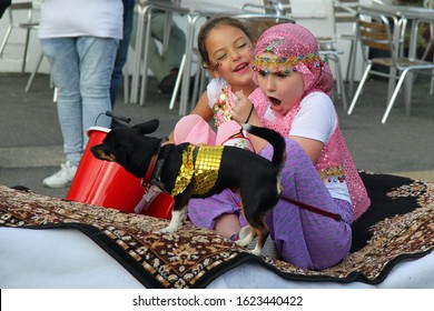 Hastings,East Sussex/UK 8-10-19 Hastings Old Town Carnival 2019 Taking Part In The Parade 2 Girls In Arabian Costumes Have Fun On Their Magic Carpet With Their Little Black Dog And Charity Bucket