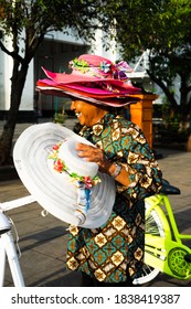 Hat And Bicycle Rental Owner Wearing Multiple Hats While Holding A White Hat. Jakarta, Indonesia. - 12 December 2019