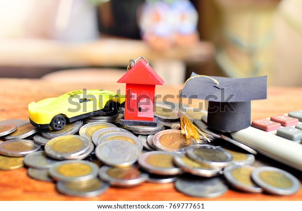 hat\
education, house model and car model on pile saving coins for\
concept loan and business finance\
investment