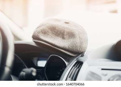 Hat on auto panel blurred photo, out of focus