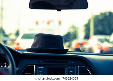 hat on dashboard while driving